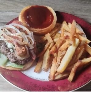 Midnight Blue Casey’s specialty burger with bacon and caramelized onions